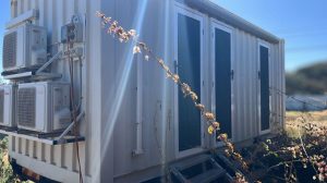 Side view of the door and air conditioning unit on on converted 20ft container custom 6 MAN accommodation